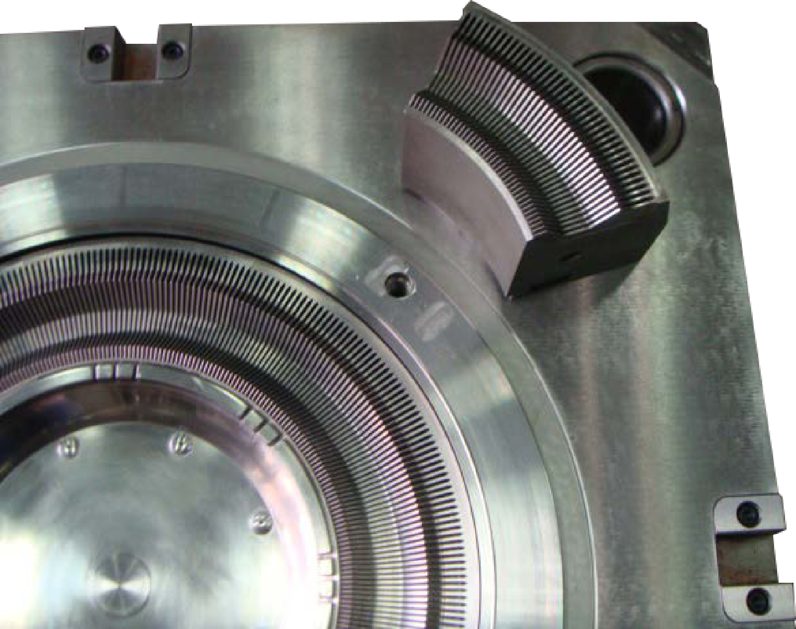 Carousel mold cavity with a curved removable section placed beside it.