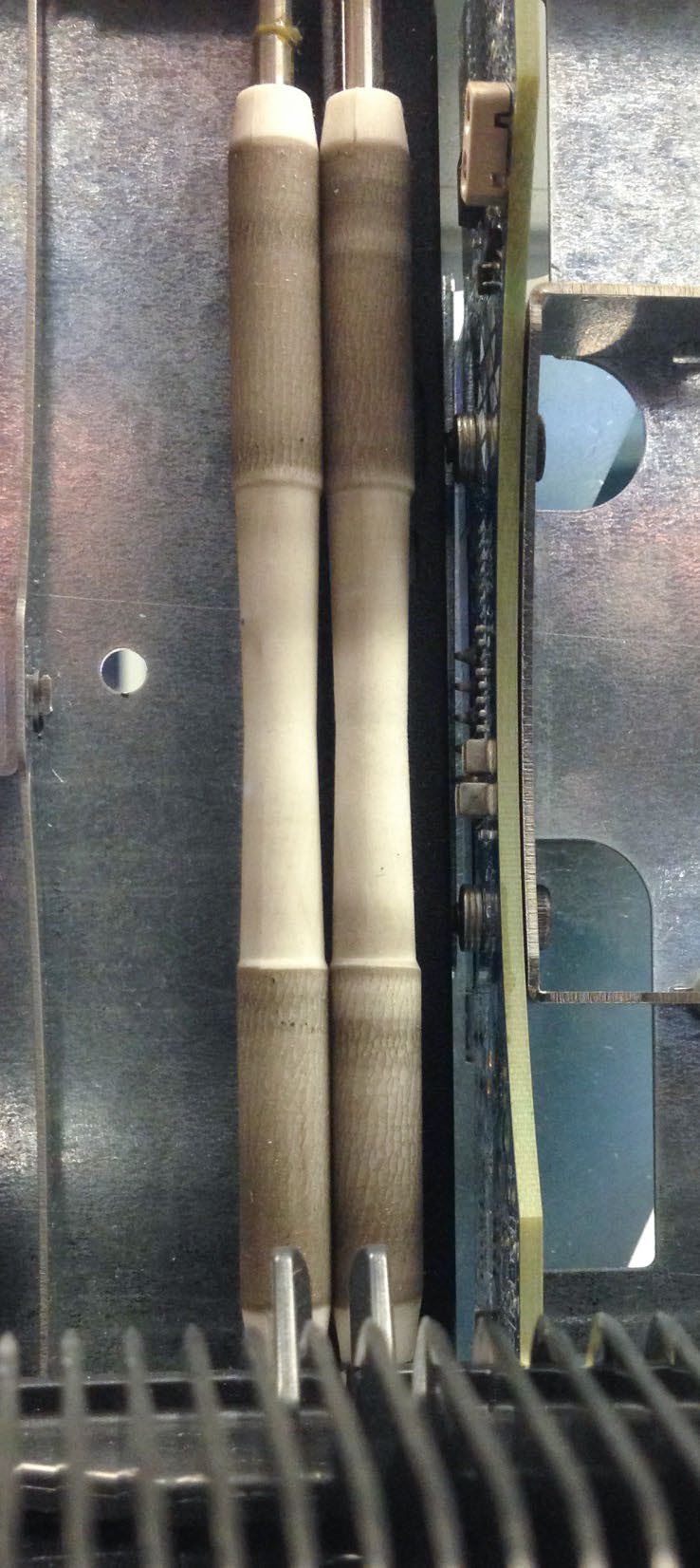 Two vertical white pinch rollers with visibly darkened contact bands beside the sensor board.