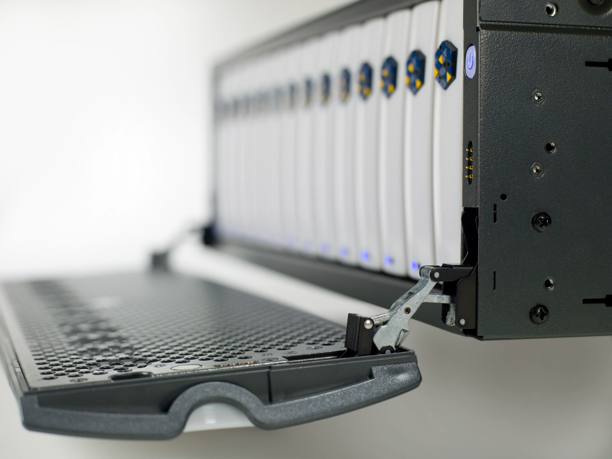 Close view of the linkage joining the open front door to the server chassis.