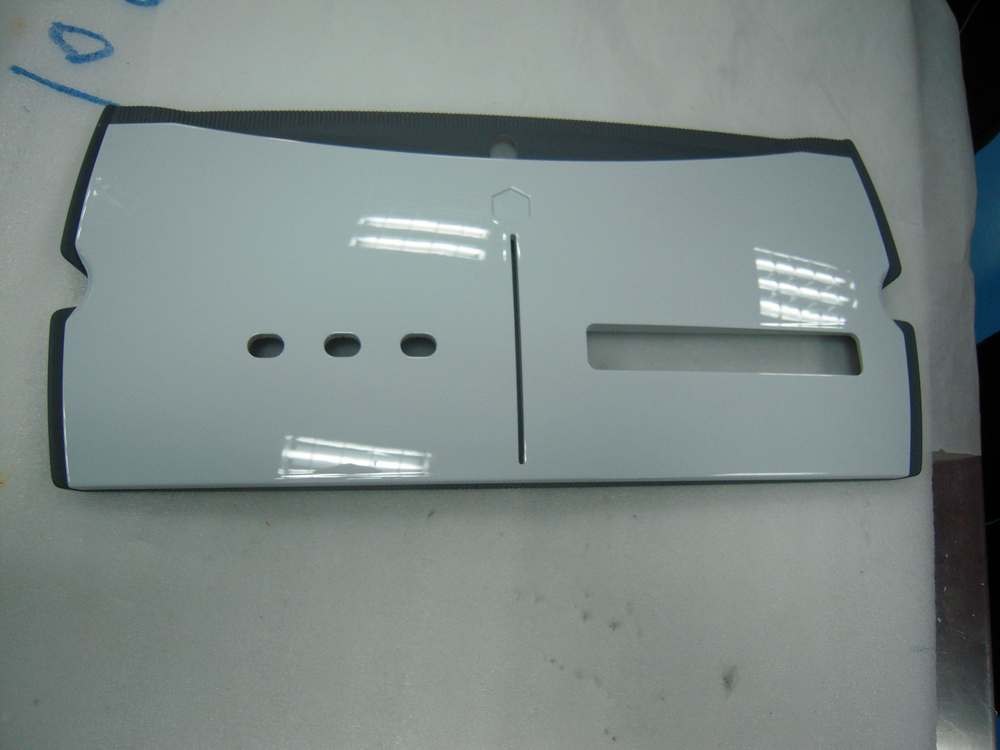 White front-bezel prototype with disc slot, three button holes and a display window.