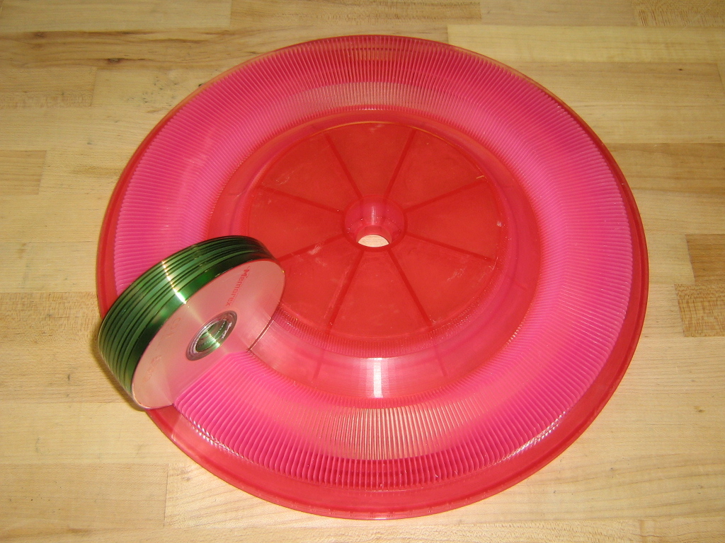 Pink SLA carousel prototype with optical discs held in its slots.